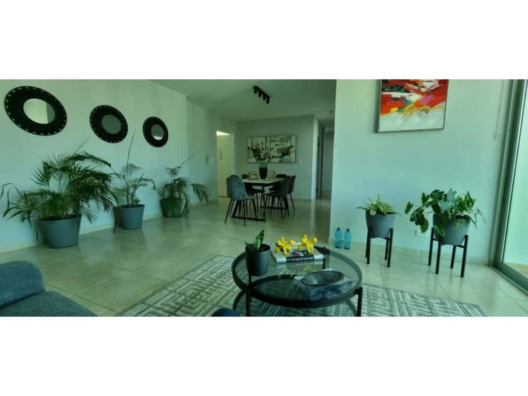 Bedroom with city view window, modern furniture PH The Seawaves Panama City.