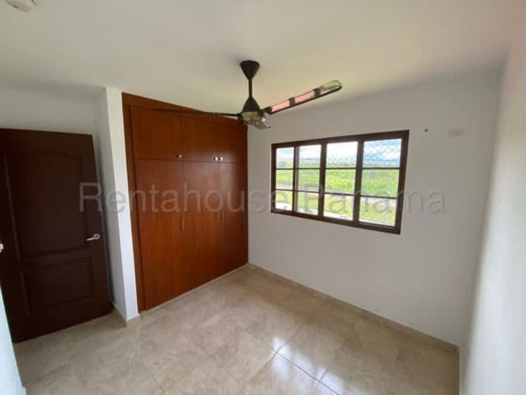 Kitchen space featuring granite counters, sink, stove and wood cabinets at Las Cumbres house for sale