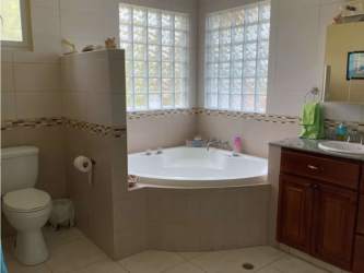 Master bedroom with jacuzzi, walk-in closet, ocean view windows in San Marino María Chiquita Panama