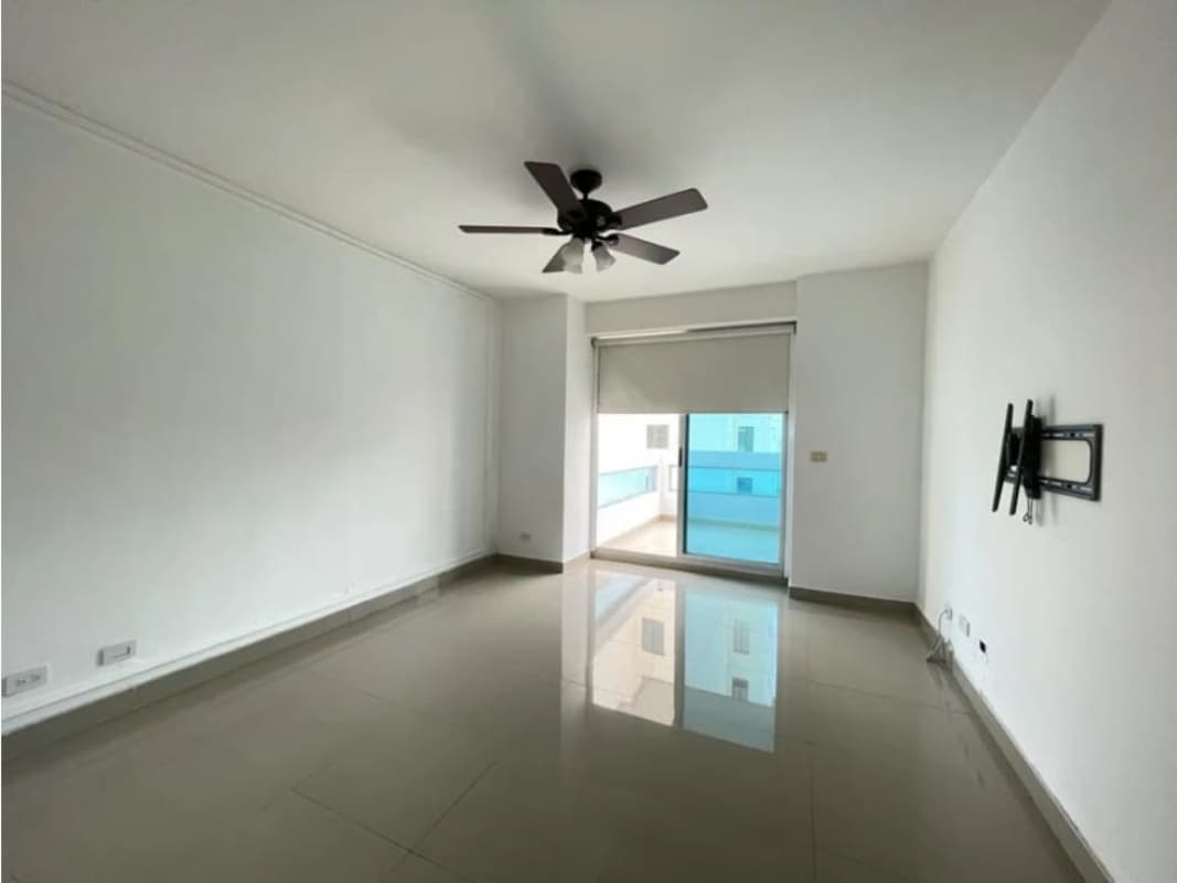 Living room with balcony, ceiling fan and glass door at The View Panama apartment