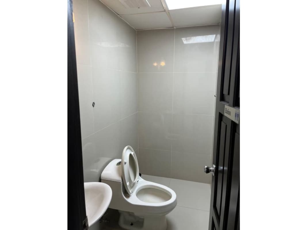 Minimalist bathroom with white fixtures inside commercial property Panama