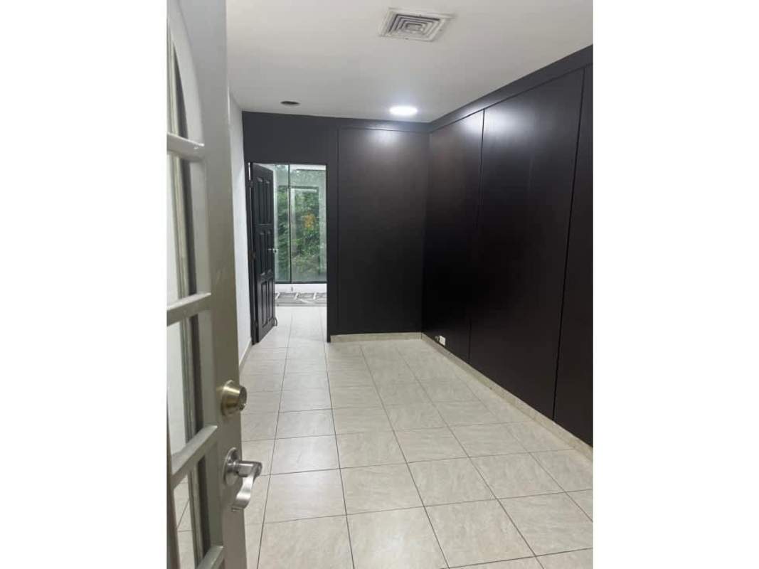 Office hallway with wood panel details and glass door PH San Francisco Business Center