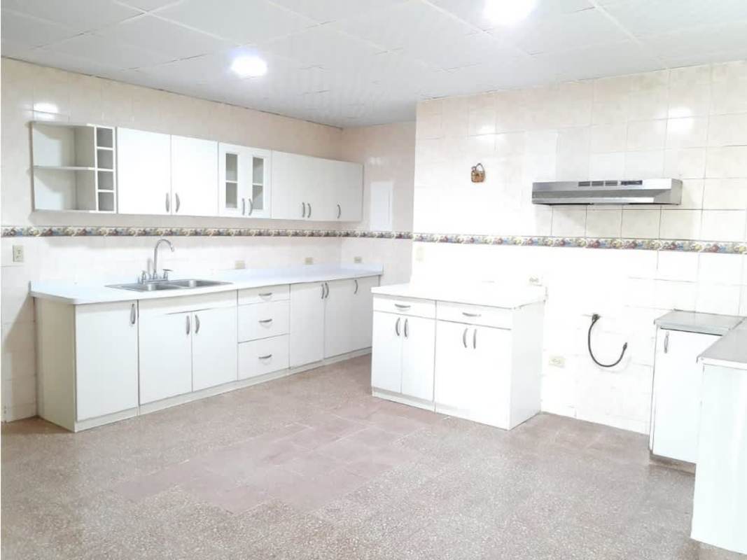Spacious kitchen with white cabinets and tile backsplash in Villa Zaita commercial residential rental Panama