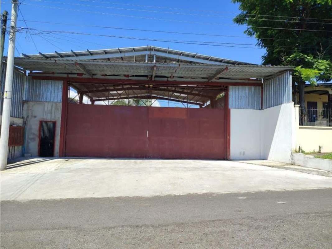 Industrial warehouse with red metal gate steel fence on Via Tocumen Panama