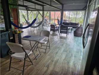 Sunroom enclosed terrace with hammocks and garden view Cerro Azul Panama