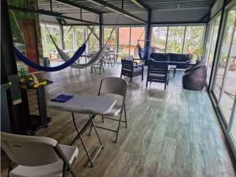 Covered outdoor balcony with railings overlooking garden and forest Cerro Azul Panama