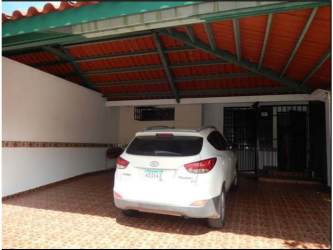 Large garden area with mature landscaping and lush grass in Howard Panama Pacifico