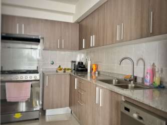 Kitchen with granite countertops, wooden cabinets, stainless appliances PH Residencias del Sol Carrasquilla Panama City