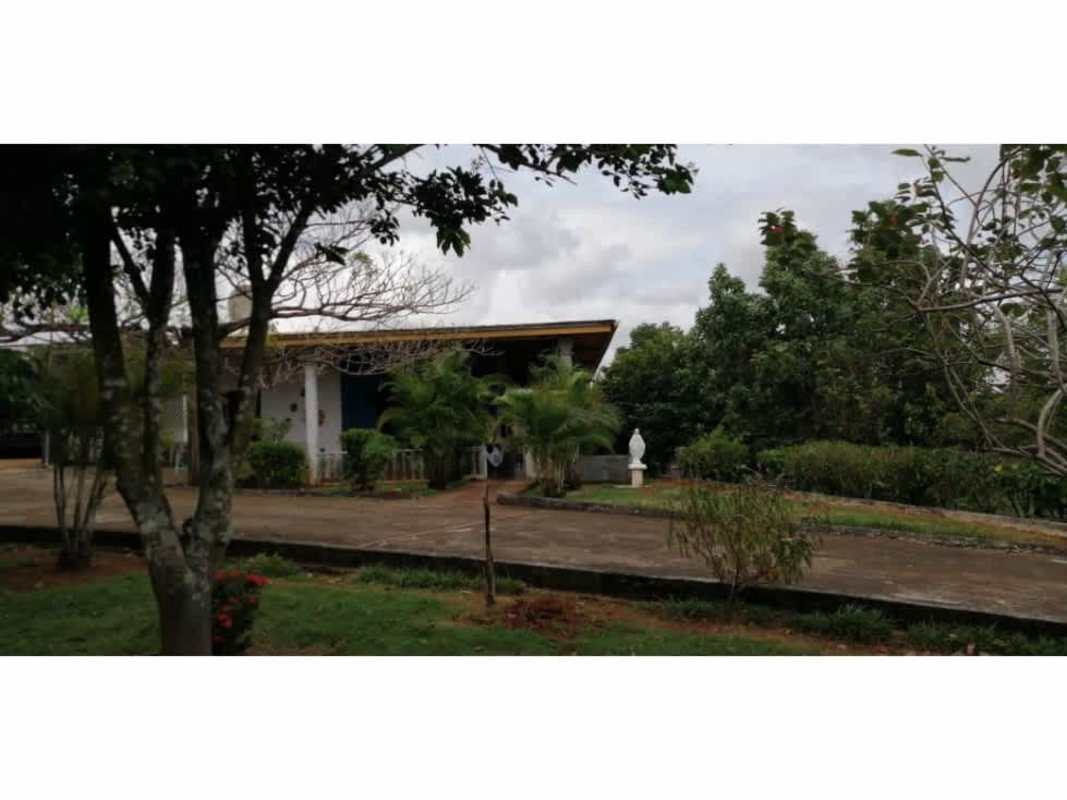 Bathroom with shower enclosure, teal fixtures, tile walls in La Higuera Chepo