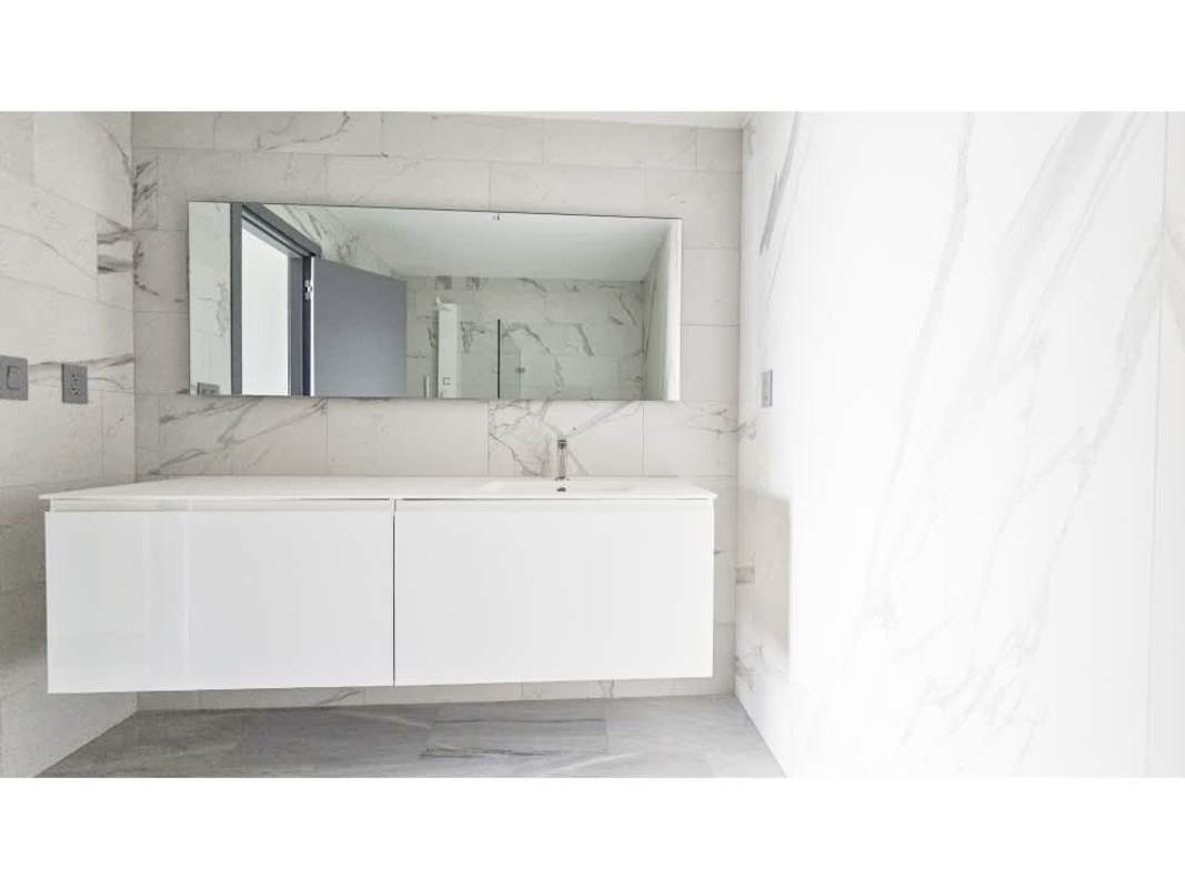 Modern bathroom marble tiles glass shower Armani Condo Panama City