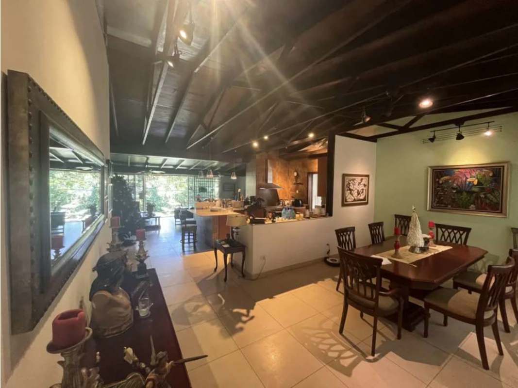 Traditional dining room with exposed wood beams, large table and garden views in Llanos de Curundu Ancon