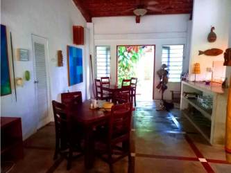 Industrial kitchen with concrete counter, pendant lights, stainless steel appliances, Playa Blanca Panama