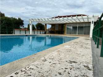 Outdoor shared swimming pool with tropical gardens Residencial Villas de La Colina Punta Chame Panama