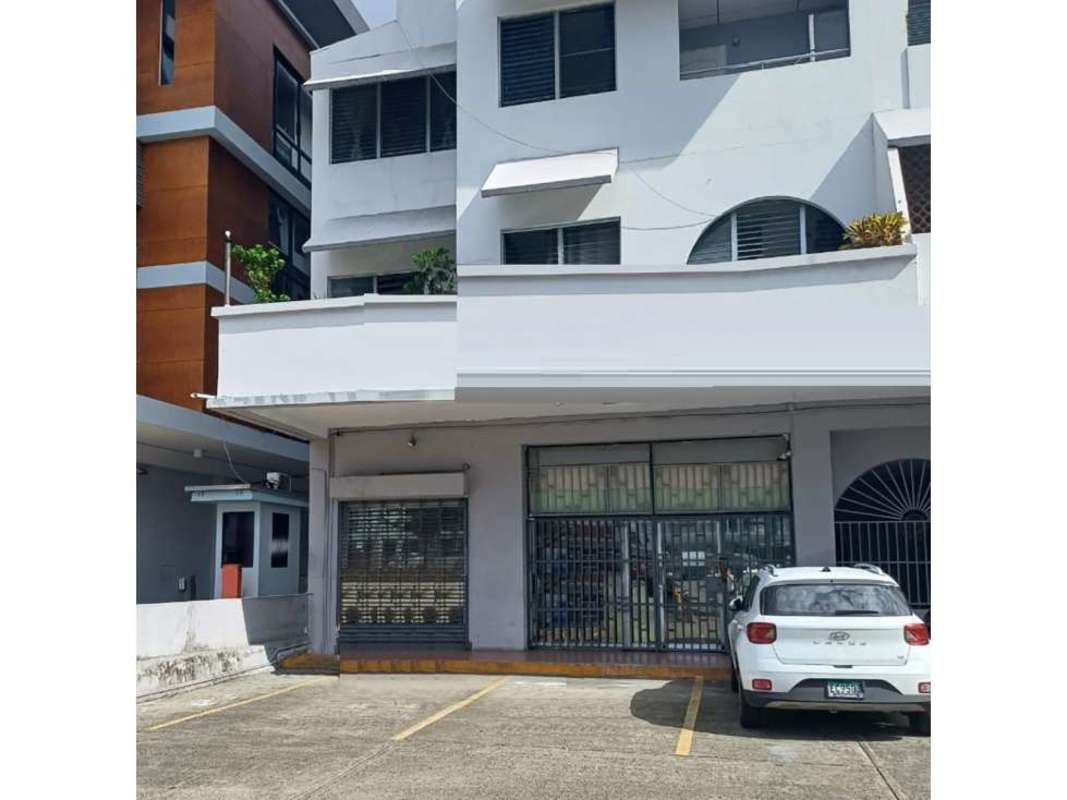 Modern reception with curved dark desk and glass blocks commercial space Bella Vista Panama