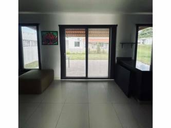 Living room open to the backyard with glass sliding doors The Village beach house Panama