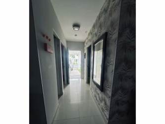 Entry hall with glossy tiles and patterned wallpaper in The Village El Palmar beach house Panama
