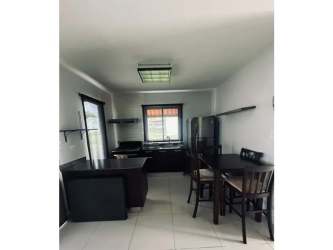 Contemporary hallway with wallpaper opening to garden beach house El Palmar Panama