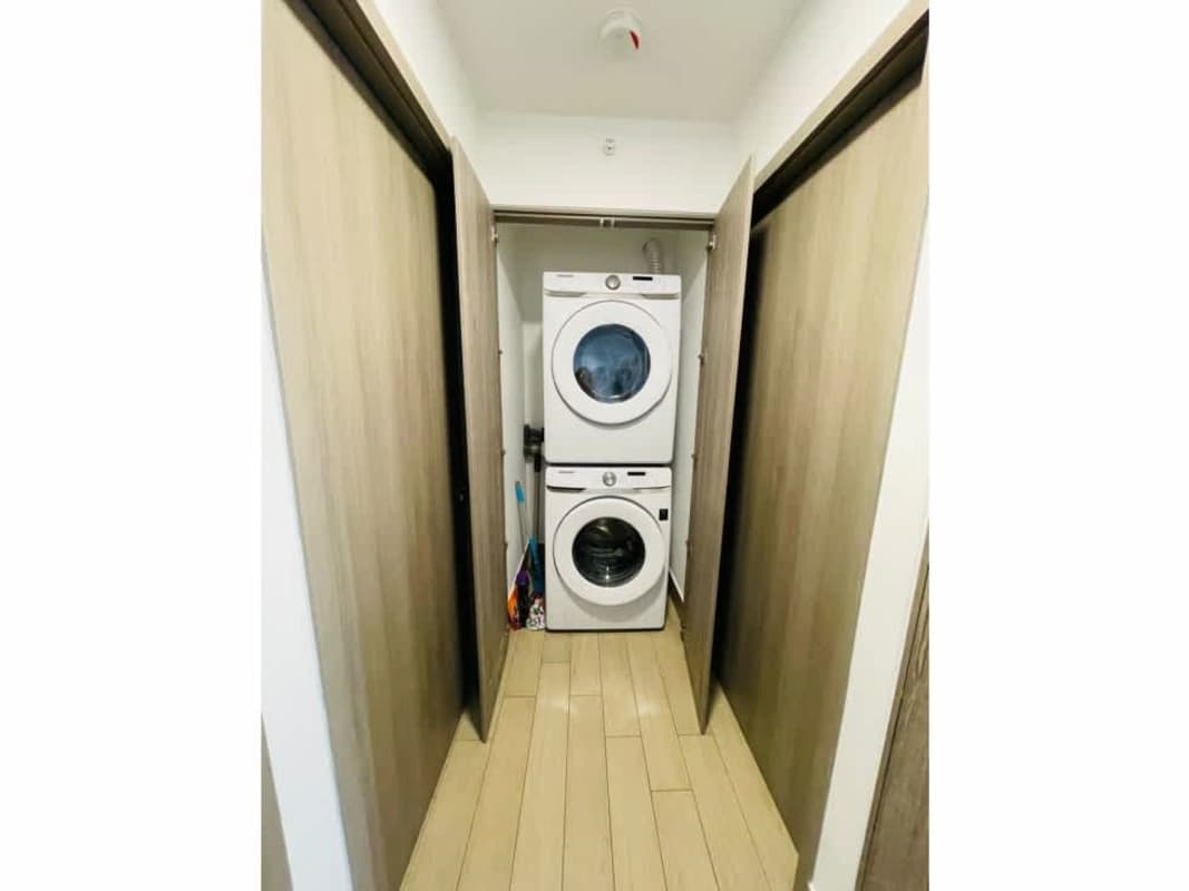 Bright living and dining room with city view balcony at PH LOV San Francisco apartment