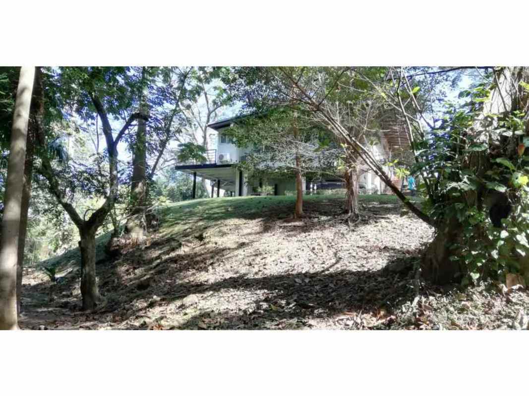Exterior of tropical style two-level house with wrap-around balconies and greenery Panama