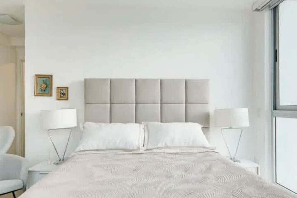 Open concept dining space with white table integrated to modern Italian kitchen in PH Marbella 47 Bella Vista Panama