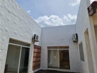 Private courtyard with white stucco walls, brick design, sliding glass beach home Panama