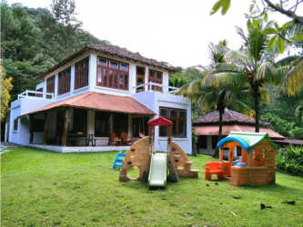Rustic bright dining area with glass table overlooking mountain greenery Panama