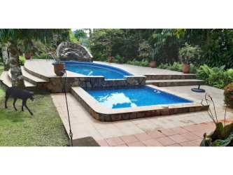 Mexican rustic kitchen with island, exposed beams, tile counters Portobelo beachfront villa Panama