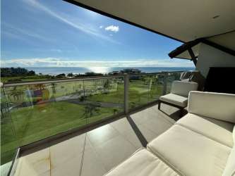 Scenic view of tropical gardens and Pacific Ocean from balcony Casamar Beachfront