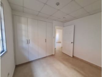 Bedroom with white built-in closet, window and tile flooring Altos Cerro Tigre house Panama