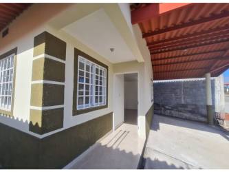 Single story house exterior with red pitched roof and carport at Altos de Cerro Tigre Arraiján Panama