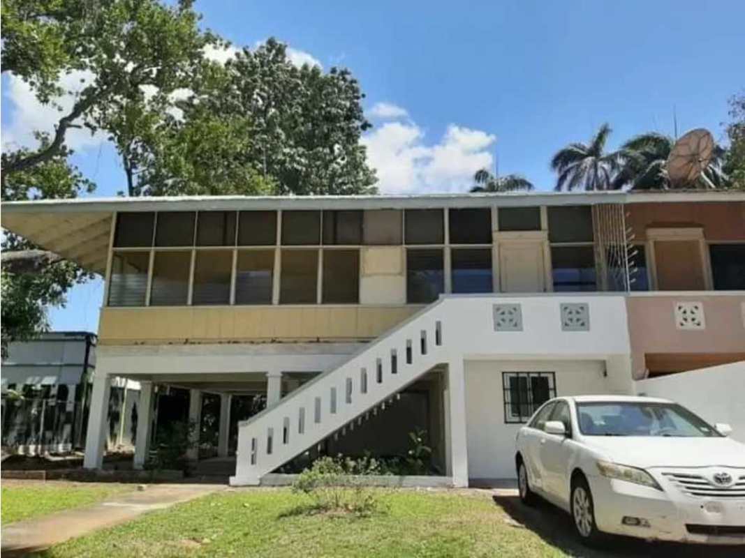 Elevated two-story duplex house with covered parking and staircase in Balboa Canal Zone