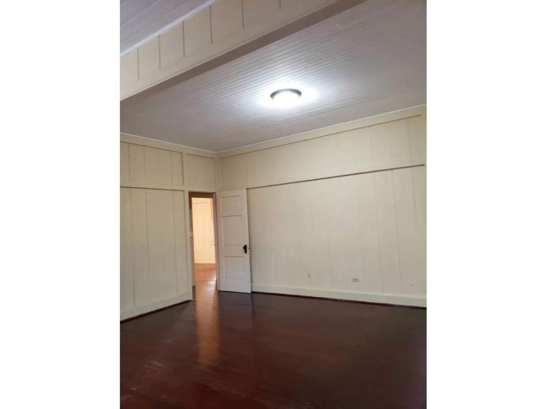 Interior empty room with wood panel walls and ceiling light fixture in Balboa Canal Zone rental house