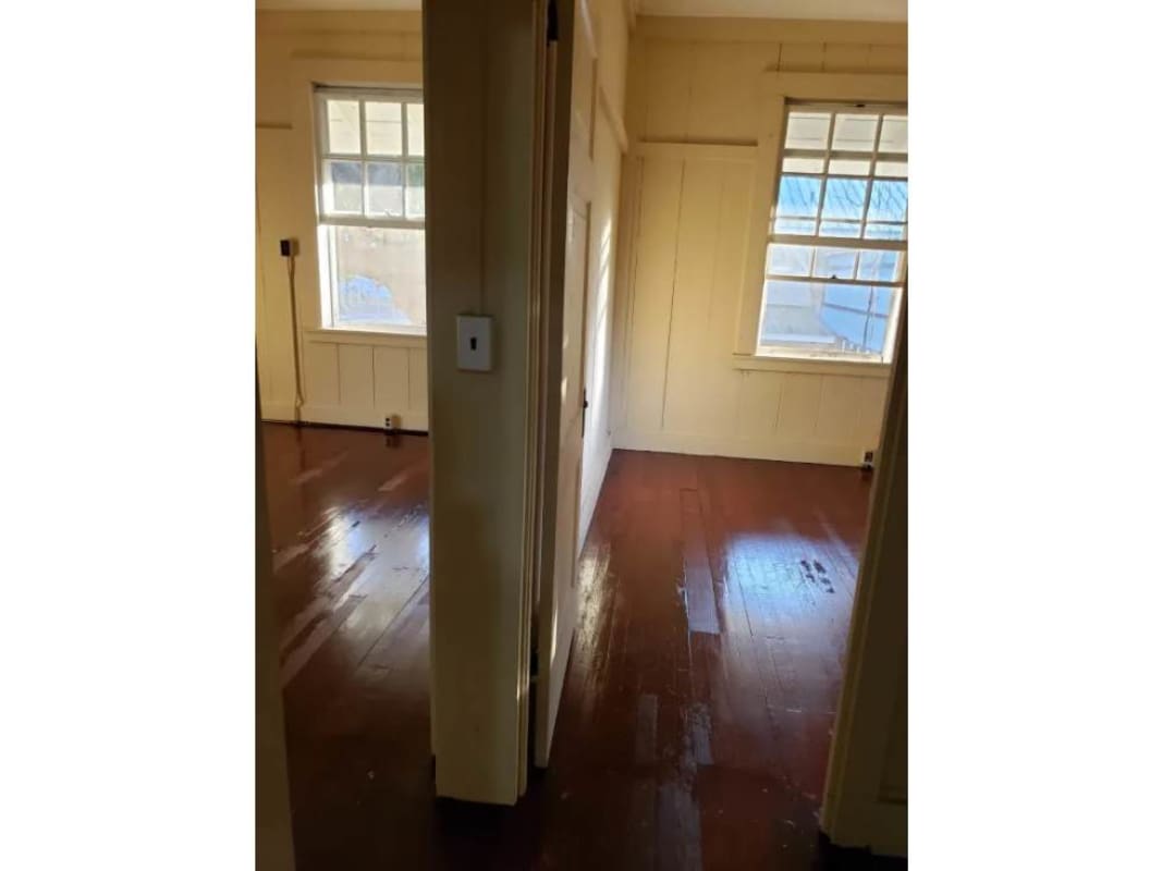 Bright bedrooms with wood floors and traditional windows in Balboa Canal Zone duplex