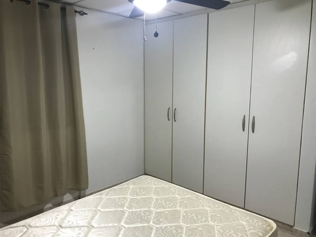 Minimalist bedroom with bed nightstand curtains tile floor PH Betania Panama City