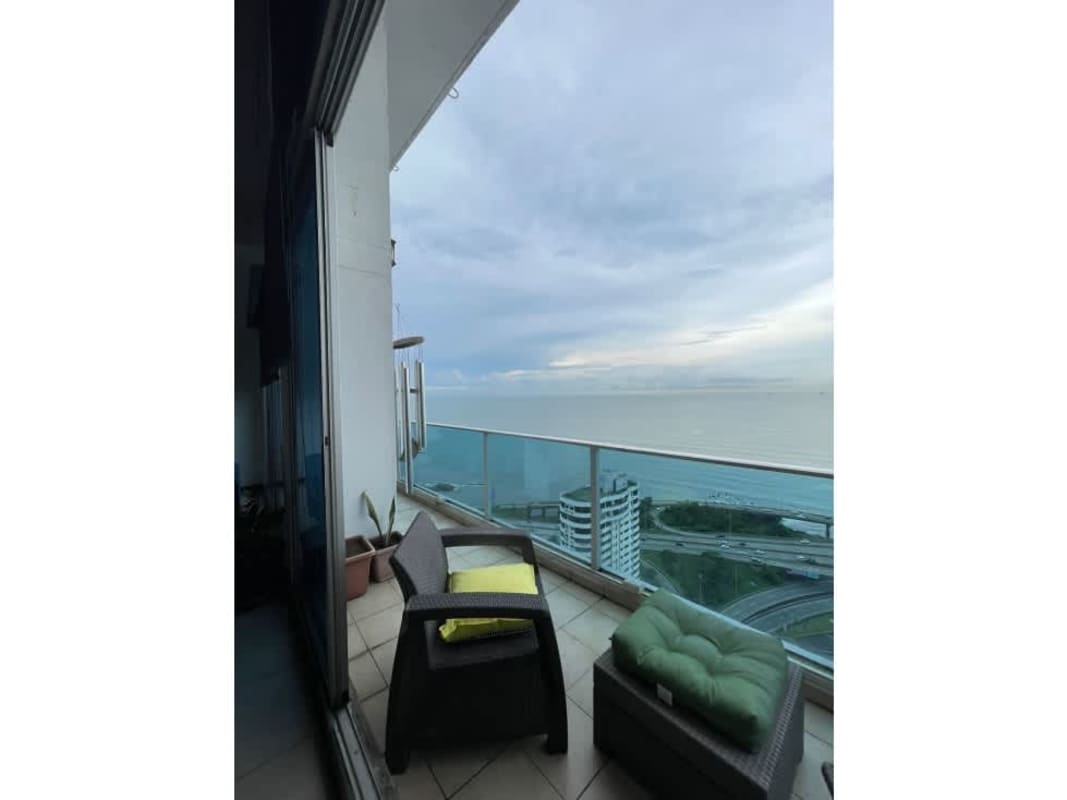 Spacious double height ceiling living room with ocean views in Coco del Mar penthouse