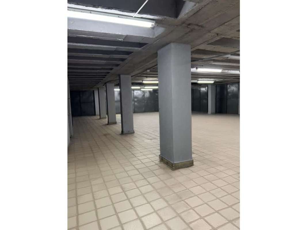 Industrial basement space with concrete supports and tile floors for warehouse use
