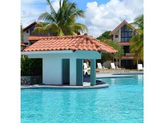 Large swimming pool with sun deck palm trees at PH Brisas de Coronado