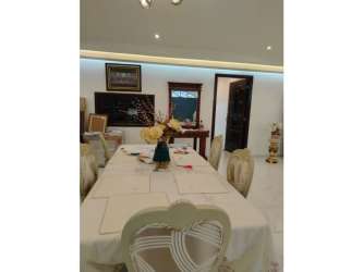 Traditional dining room adjacent to terrace in Buena Vista Colón house for sale.