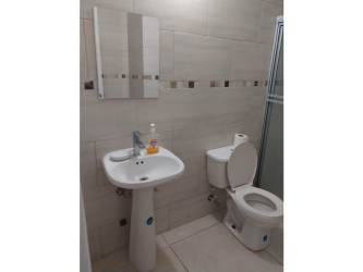 Contemporary bathroom with glass-enclosed shower and modern tiles in Arraiján house
