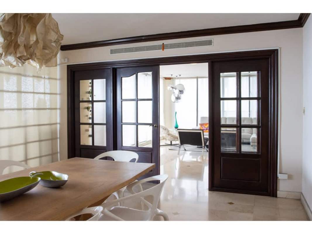 Luxury living room space with marble ceramic floors, balcony access, and panoramic skyline views in Avenida Balboa Condo Panama City