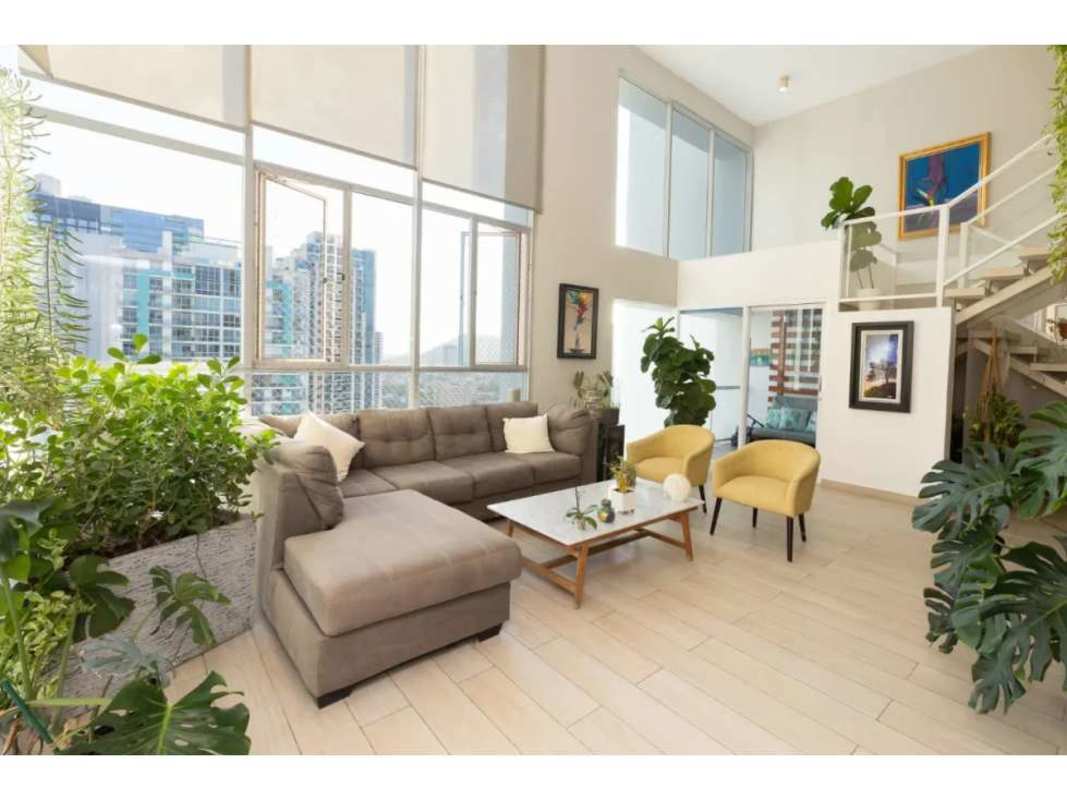 Open plan loft living and dining area with city views in PH Blue Park Bella Vista Panama