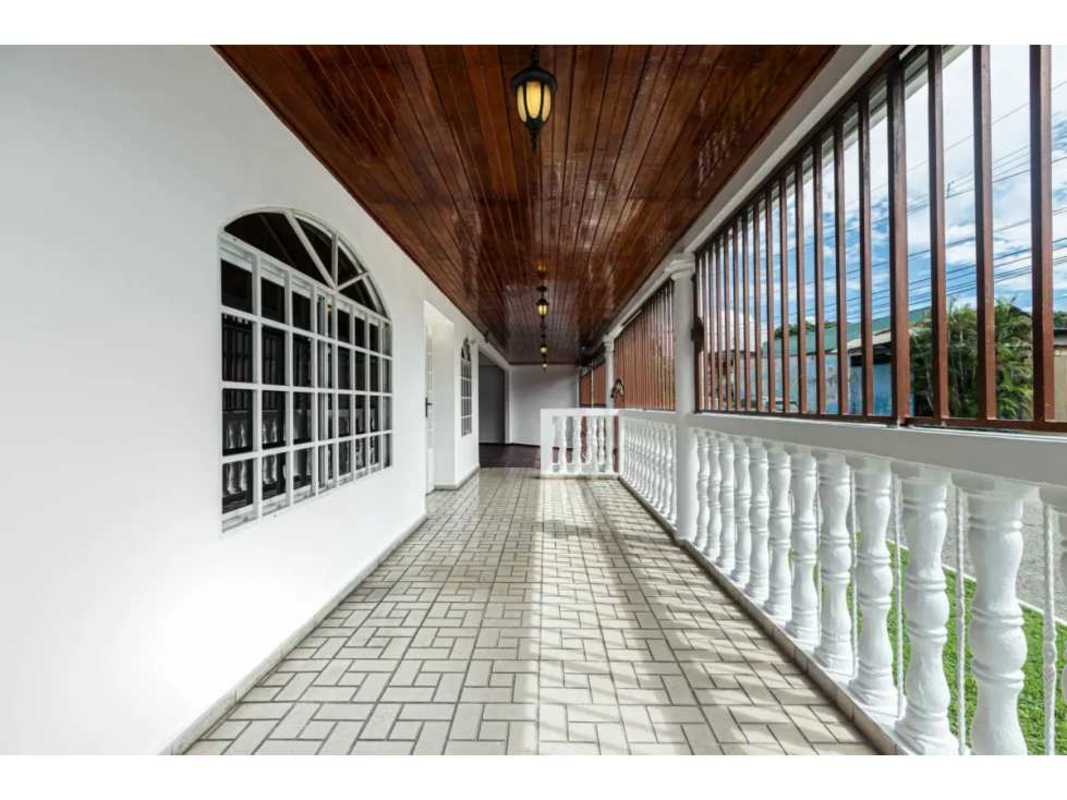 Ample garage area with red tile floor and wooden ceiling in Villa Rica Rio Abajo Panama
