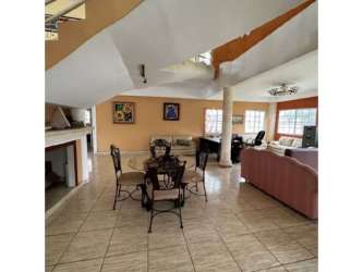 Large fenced garden yard next to luxury multi-story estate house in David Panama