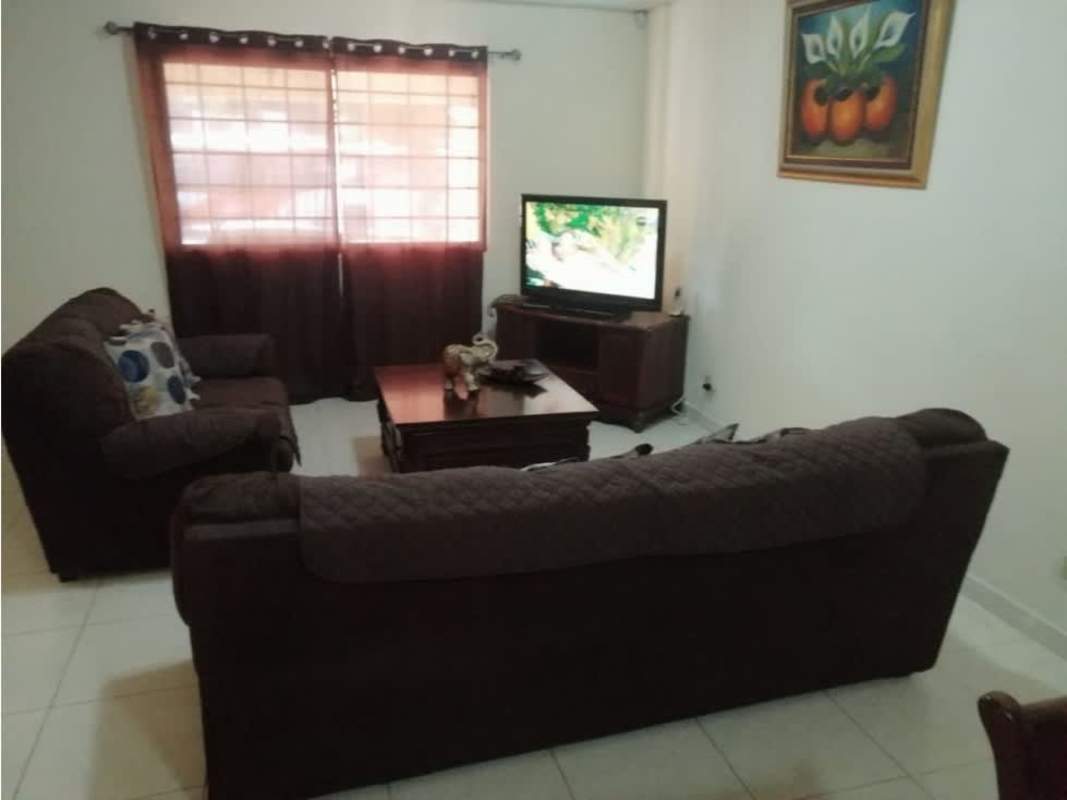 Spacious furnished living room with blue accent wall, sofa set and tiled floors in Cerro Viento Panama City