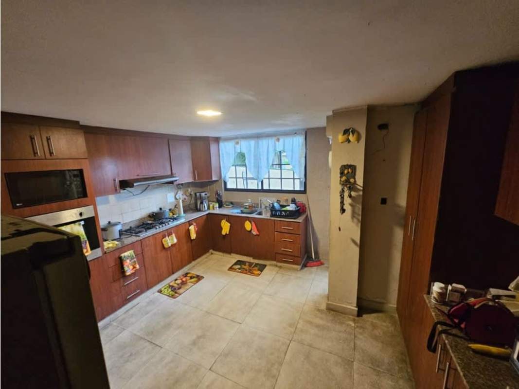 Large kitchen with granite counter tops, wooden cabinetry and stainless appliances Villa Zaita Panama