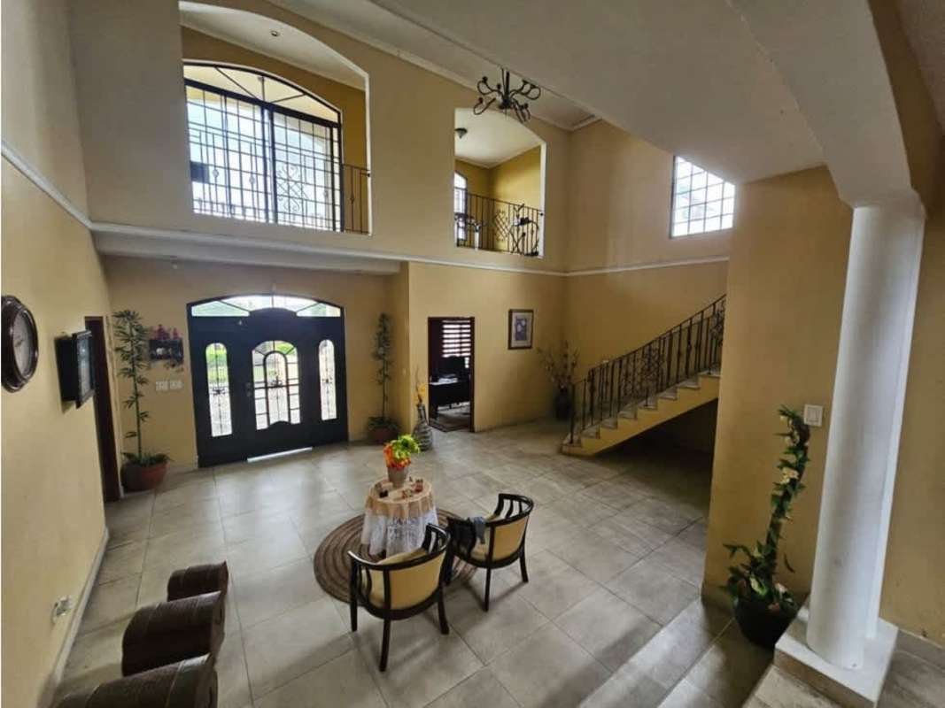 Grand entrance foyer with double height ceiling and stairway in upscale villa Villa Zaita Panama