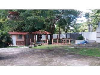 Covered patio with fan and dining table in luxury Coronado property with wooden ceiling beams