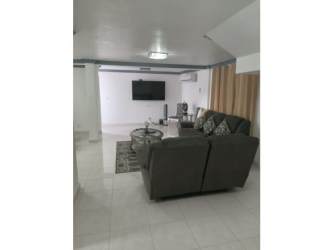 Large furnished living room with sofas, ceiling fan, tile floors at Altos de Panamá house for rent