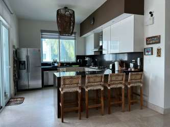 Contemporary kitchen with breakfast bar and appliances in Bijao beach condo Panama