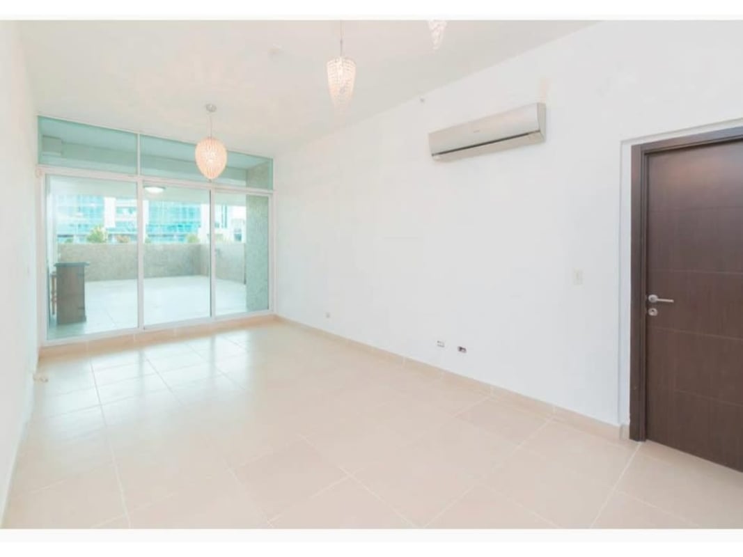 Bright living room with sliding doors to private terrace in PH Kings Park Condado del Rey Panama City